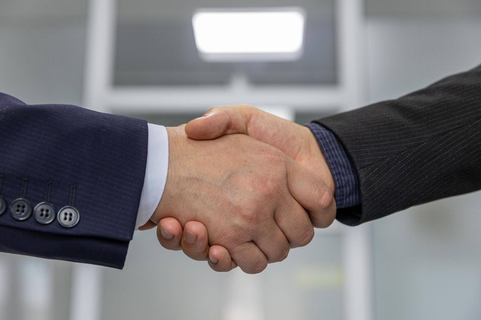Two people shaking hands after a business meeting