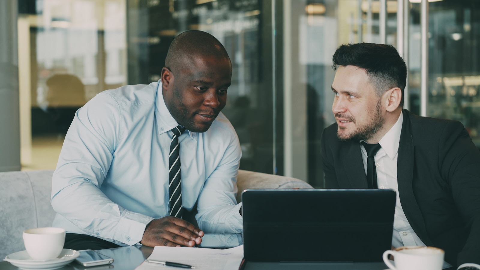 A founder on a video call with an advisor, reviewing a laptop screen together